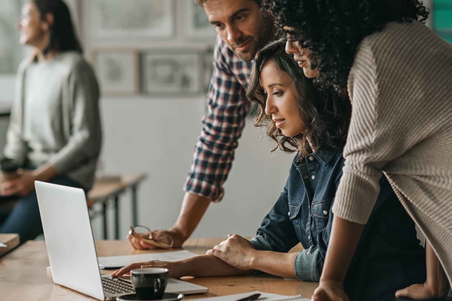 team looking at computer in office