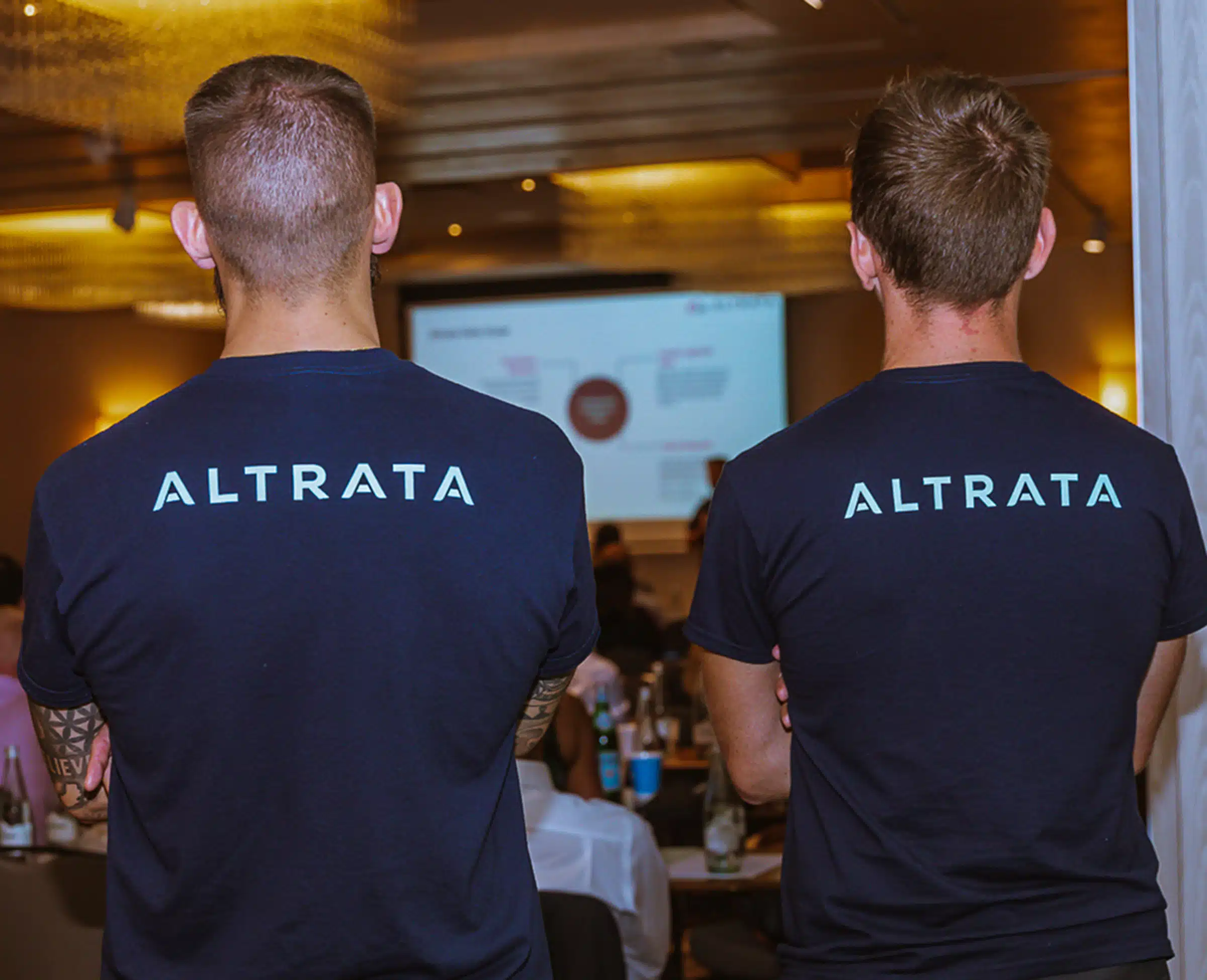 Back of two Altrata employees