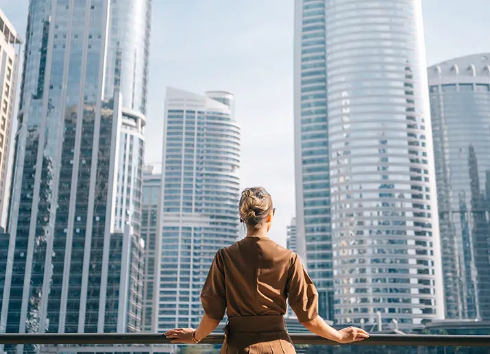 Female business leaders looking over city skyline