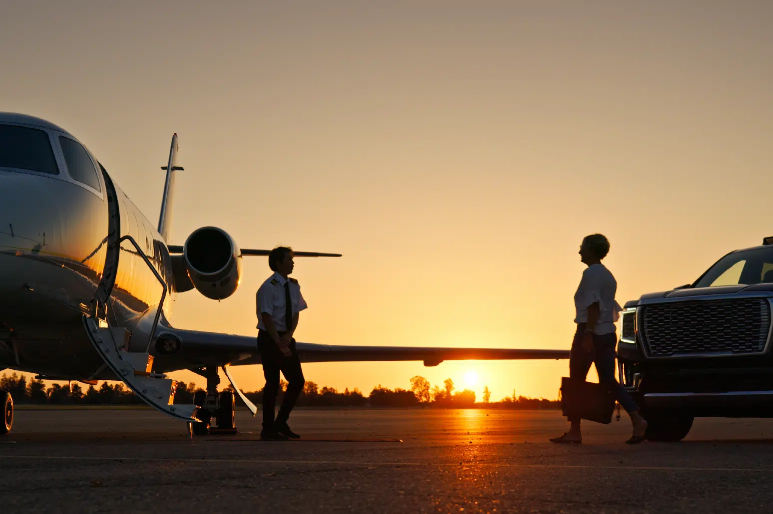 Individual walking towards pilot and private plane.