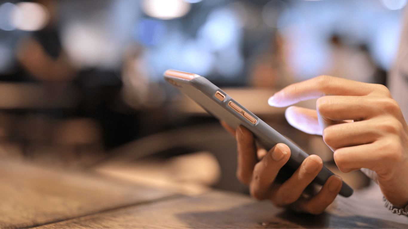 Next Gen donor using phone to engage digitally with nonprofits