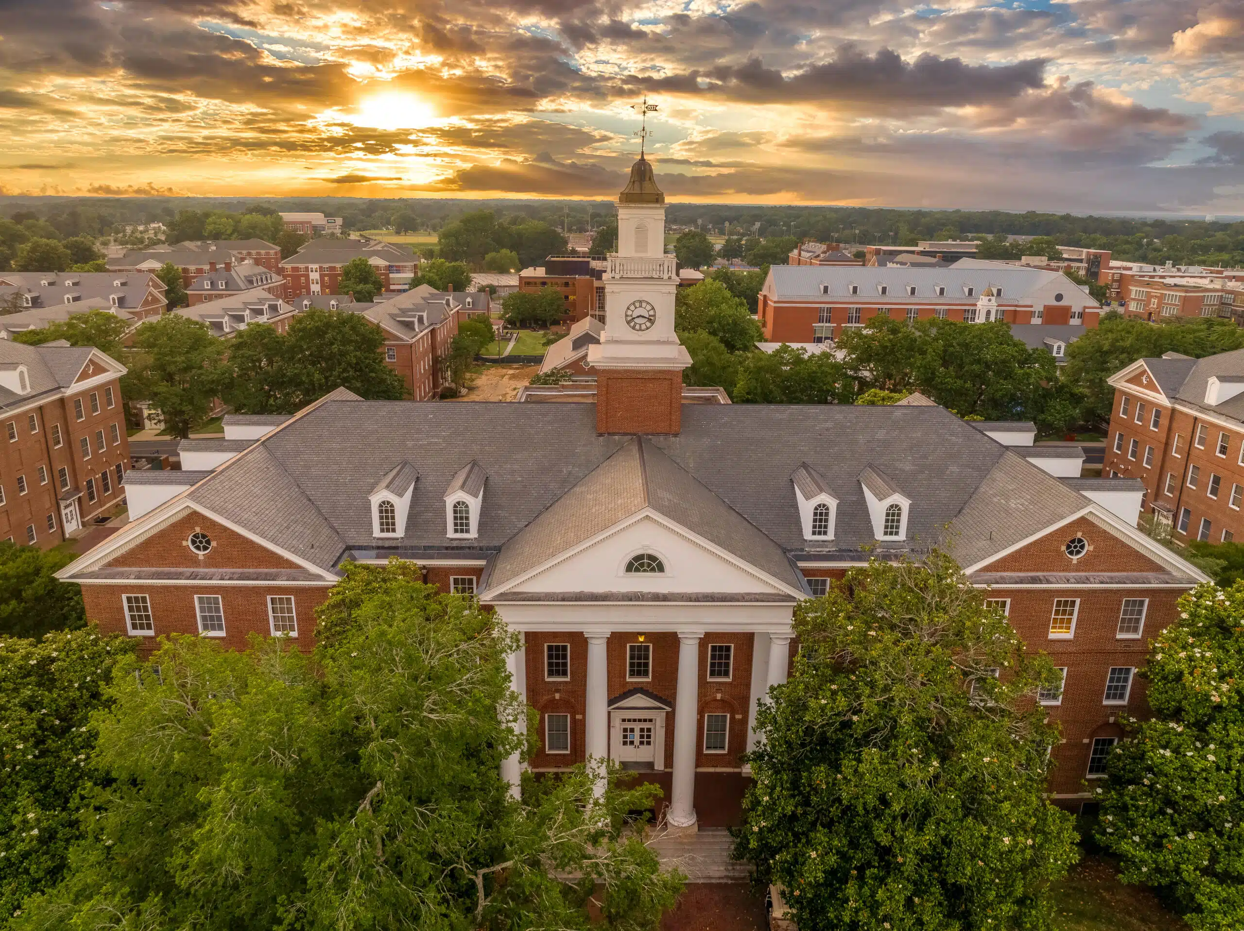 Aerial view of Virginia State University in Petersburg, Virginia Hall central building with stunning dramatic colorful sunset sky. Cover image for Altrata's University Alumni Report.