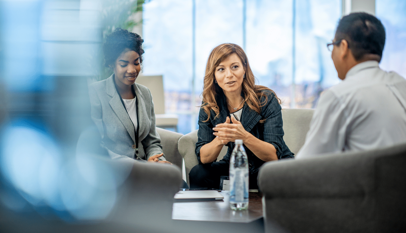 RIAs sitting at a boardroom table discussing wealth management strategies in 2025.