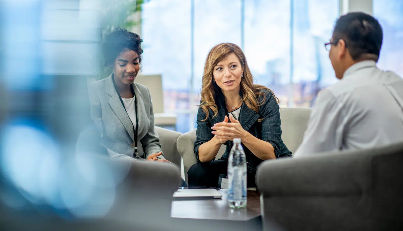 RIAs sitting at a boardroom table discussing wealth management strategies in 2025.