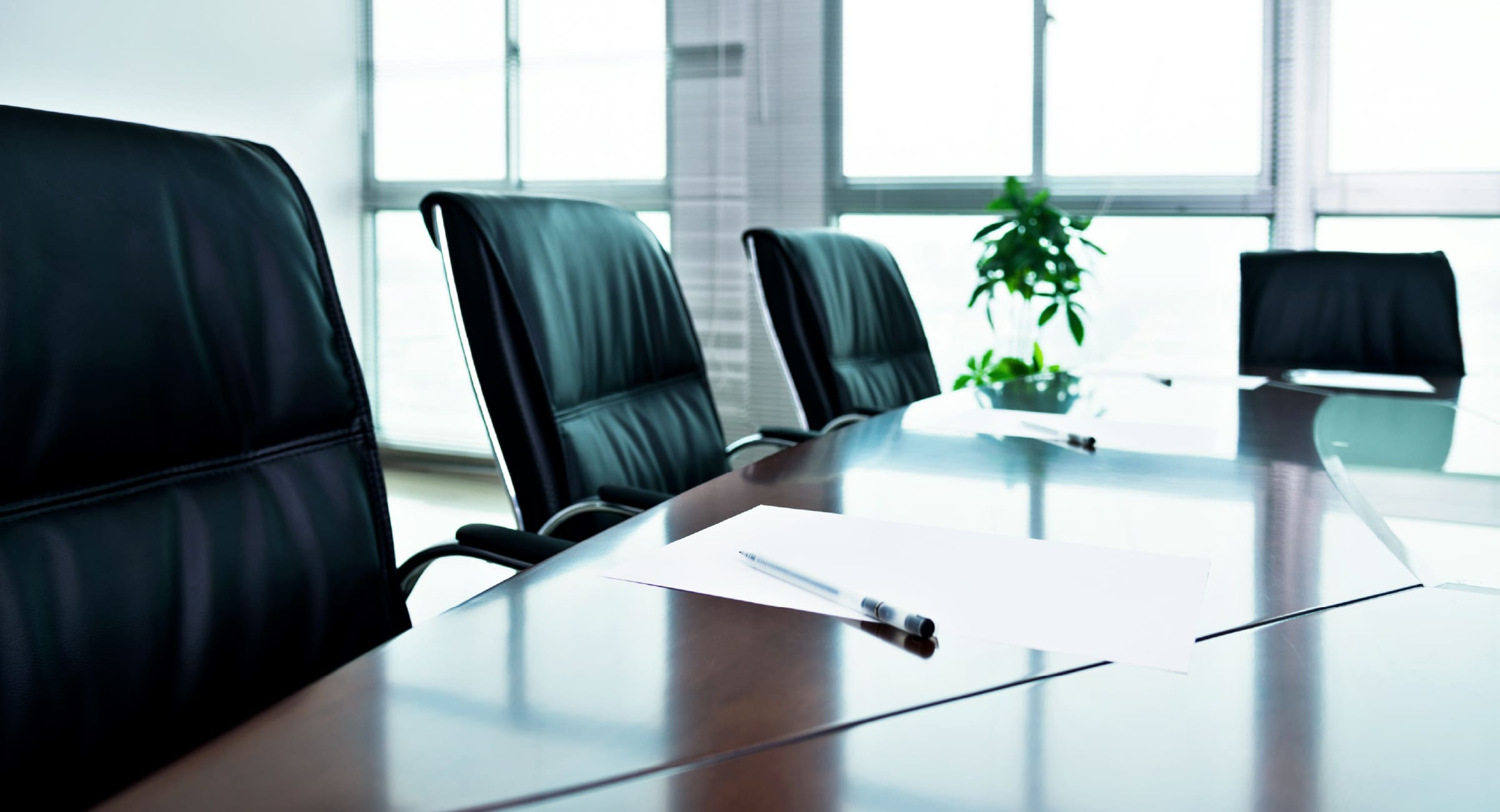 Executive boardroom with empty chairs